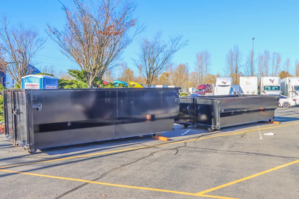 Professional dumpster rental service with roll-off container on residential driveway in Raleigh Hills